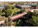Aerial view of community amenities, featuring a pool, bridge, and landscaped areas, showcasing a vibrant community lifestyle at 42311 W Good Vibrations Ln, Maricopa, AZ 85138