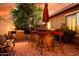 Charming outdoor bar area with seating and grill, set against a scenic backyard, great for outdoor cooking and dining at 42311 W Good Vibrations Ln, Maricopa, AZ 85138