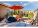 The backyard showcases an outdoor kitchen and dining area, complete with a grill and bar seating at 42311 W Good Vibrations Ln, Maricopa, AZ 85138