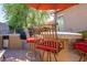 Outdoor kitchen bar with red cushioned seating, offering a stylish space for entertaining and grilling at 42311 W Good Vibrations Ln, Maricopa, AZ 85138