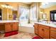 Elegant bathroom featuring a soaking tub, double sinks, and large mirrors, offering a spa-like experience at 42311 W Good Vibrations Ln, Maricopa, AZ 85138