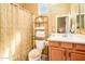 Well-lit bathroom with a bathtub shower, a vanity, a toilet, a neutral color scheme and shelving at 42311 W Good Vibrations Ln, Maricopa, AZ 85138