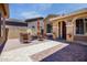 Inviting courtyard with a stylish fire pit table and ample seating, perfect for outdoor entertaining and relaxation at 42311 W Good Vibrations Ln, Maricopa, AZ 85138