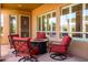 Covered patio includes a circular fire pit with four swivel chairs at 42311 W Good Vibrations Ln, Maricopa, AZ 85138