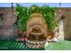 Outdoor fountain and greenery create a peaceful backyard focal point at 42311 W Good Vibrations Ln, Maricopa, AZ 85138