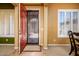 Inviting foyer features security door, neutral color palette, tile flooring, and plantation shutters at 42311 W Good Vibrations Ln, Maricopa, AZ 85138