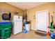 This garage features essential utilities, like a refrigerator, water heater, and water softener at 42311 W Good Vibrations Ln, Maricopa, AZ 85138