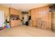Spacious garage features ample storage cabinets, built-in shelving, and a well-organized tool area at 42311 W Good Vibrations Ln, Maricopa, AZ 85138