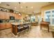 Spacious kitchen and dining area featuring a large center island and tile flooring throughout at 42311 W Good Vibrations Ln, Maricopa, AZ 85138