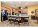 Kitchen island with granite countertops, barstool seating, stainless steel appliances, and wine fridge at 42311 W Good Vibrations Ln, Maricopa, AZ 85138