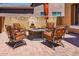 Cozy outdoor patio with comfortable seating and a charming water feature, ideal for relaxing and enjoying the outdoors at 42311 W Good Vibrations Ln, Maricopa, AZ 85138
