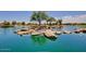 Scenic pond with rock features and lush surroundings, creating a peaceful retreat in the community landscape at 42311 W Good Vibrations Ln, Maricopa, AZ 85138