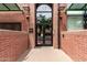 Stadium Lofts entrance featuring a brick facade, stylish glass doors, and exterior lighting at 424 S 2Nd St # 306, Phoenix, AZ 85004