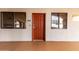 Condo entrance featuring a vibrant red door, unit number 306, and adjacent windows for natural light at 424 S 2Nd St # 306, Phoenix, AZ 85004