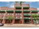 Attractive brick building featuring green balconies and awning, providing a stylish urban living experience at 424 S 2Nd St # 306, Phoenix, AZ 85004