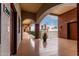 Bright hallway overlooking the city with arched walkways, brown brick walls, and potted plants at 424 S 2Nd St # 306, Phoenix, AZ 85004
