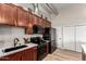 Well-lit kitchen showcasing stainless steel appliances, stylish backsplash, and wood cabinets at 424 S 2Nd St # 306, Phoenix, AZ 85004
