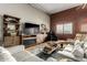 Chic living room boasting a brick accent wall, modern furniture, and stylish decor at 424 S 2Nd St # 306, Phoenix, AZ 85004