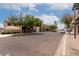 A sunny street view of multiple storefronts with plenty of parking and foliage at 424 S 2Nd St # 306, Phoenix, AZ 85004