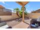 Relaxing patio with tiled flooring, desert landscaping and palm trees at 4519 E Amberwood Dr, Phoenix, AZ 85048