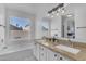 Bright bathroom features dual sinks, a soaking tub, granite countertops, and tile flooring at 4519 E Amberwood Dr, Phoenix, AZ 85048