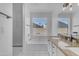 Bright bathroom with a soaking tub, separate shower, dual sinks, and granite countertops at 4519 E Amberwood Dr, Phoenix, AZ 85048