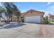 Charming single-story home with a spacious driveway, well-manicured landscaping, and attached two-car garage at 4519 E Amberwood Dr, Phoenix, AZ 85048