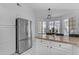 Kitchen with stainless steel refrigerator, white cabinets, granite countertops, and breakfast nook at 4519 E Amberwood Dr, Phoenix, AZ 85048
