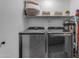Modern laundry room featuring front loading washer and dryer with storage shelving at 4519 E Amberwood Dr, Phoenix, AZ 85048