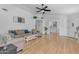 Spacious living room with hardwood floors, ceiling fan and neutral decor, creating an airy and inviting atmosphere at 4519 E Amberwood Dr, Phoenix, AZ 85048