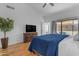 Large main bedroom features wood floors and sliding doors to the patio at 4519 E Amberwood Dr, Phoenix, AZ 85048