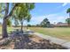 Community park featuring a stone picnic table and a vast grassy area, ideal for relaxation and outdoor activities at 4519 E Amberwood Dr, Phoenix, AZ 85048