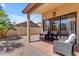 Private patio with tiled flooring, comfortable seating, and gravel landscaping at 4519 E Amberwood Dr, Phoenix, AZ 85048