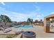 Community pool and lounge area with ample seating for residents, featuring a clear blue pool, and nearby foliage at 4519 E Amberwood Dr, Phoenix, AZ 85048