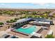 Scenic aerial view of the community pool and recreational center, surrounded by lush landscaping and homes at 4741 E Fire Opal Ln, San Tan Valley, AZ 85143