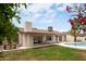 Spacious backyard view featuring in-ground pool, lush lawn, patio, and mature landscaping at 4948 E Evans Dr, Scottsdale, AZ 85254