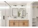 Bright bathroom features double sinks, quartz countertops and modern light fixtures at 4948 E Evans Dr, Scottsdale, AZ 85254