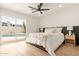 Bedroom with access to a backyard pool featuring a ceiling fan and modern decor at 4948 E Evans Dr, Scottsdale, AZ 85254