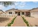 Inviting home with a cozy front entryway, lush bougainvillea, desert landscaping, and a covered entry at 4948 E Evans Dr, Scottsdale, AZ 85254