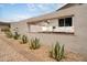 Stylish outdoor area with a built-in fireplace feature, comfortable seating, and desert plants at 4948 E Evans Dr, Scottsdale, AZ 85254