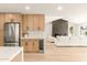 Modern living room with a fireplace, and connected to a bright kitchen with stainless steel appliances at 4948 E Evans Dr, Scottsdale, AZ 85254