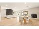 Open concept living and dining area with modern fireplace and backyard pool access at 4948 E Evans Dr, Scottsdale, AZ 85254