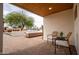 Inviting covered patio with outdoor seating overlooking a beautifully landscaped courtyard, blending indoor and outdoor living at 4948 E Evans Dr, Scottsdale, AZ 85254