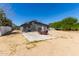 Backyard featuring basketball hoop, outdoor seating area, and desert landscape at 511 E Purdue Ave, Phoenix, AZ 85020