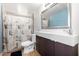 This bathroom has tile floors, a modern sink, and a shower with a patterned curtain at 511 E Purdue Ave, Phoenix, AZ 85020