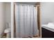 View of bathroom featuring tile shower behind patterned curtain and modern vanity at 511 E Purdue Ave, Phoenix, AZ 85020