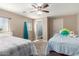 Bright bedroom featuring neutral walls, ceiling fan, two beds, and natural light at 511 E Purdue Ave, Phoenix, AZ 85020
