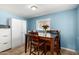 Cozy dining room with wood table, seating for six and white storage cabinets at 511 E Purdue Ave, Phoenix, AZ 85020