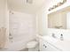 Bright bathroom featuring a shower-tub combination with modern fixtures and clean design at 53404 W Candlelight Rd, Maricopa, AZ 85139