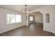 Bright dining area with wood floors and open access to other living spaces in the home at 53404 W Candlelight Rd, Maricopa, AZ 85139